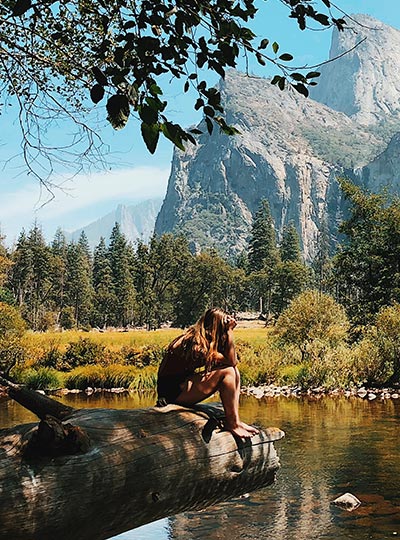Fotografie Adély sedící na kameni a hledící do krajiny